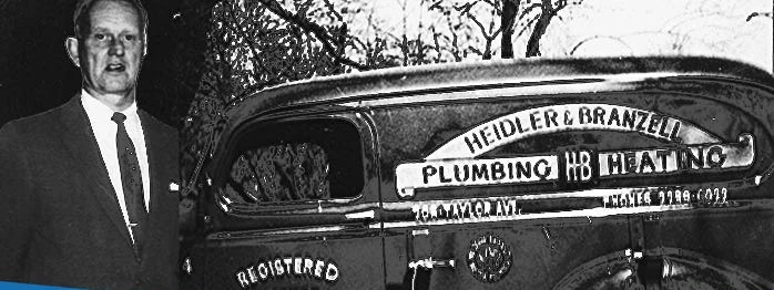 Founder standing beside the original Heidler & Branzell Plumbing & Heating truck in Annapolis