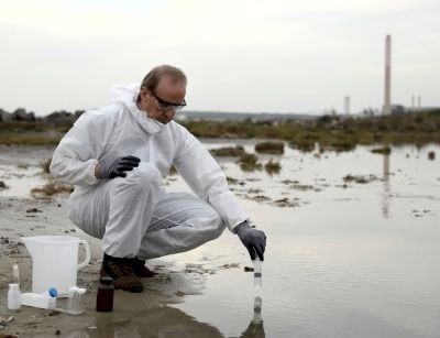man testing pollutants in water