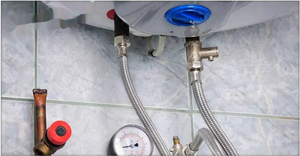 Boiler supply and return lines with a pressure gauge during a maintenance visit