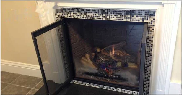 Gas fireplace with the glass door open after service in an Annapolis home