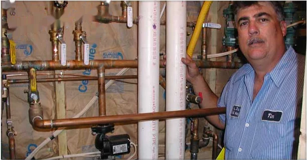 Heidler technician beside newly installed copper gas and hydronic heating lines