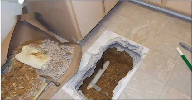 Tile floor opened to expose and repair a slab leak in an Annapolis home
