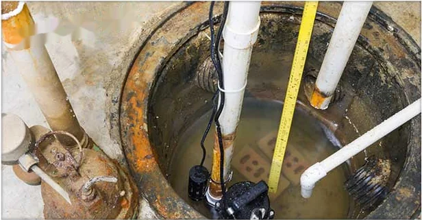 Installed sump pump and discharge piping in a residential sump pit